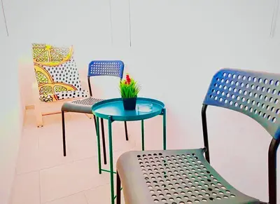 a table with a plant on it next to two chairs at M&M Apartment I SELF CHECK-IN near Panevezys in Velžys