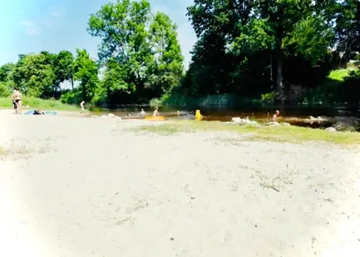 a group of people laying on the sand on a beach at M&M Apartment I SELF CHECK-IN near Panevezys in Velžys
