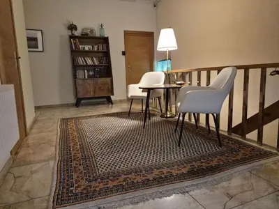 a living room with two chairs and a table at Nėris Inn Terraces in Vilnius