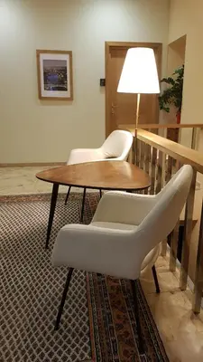 a room with a table and two chairs and a lamp at Nėris Inn Terraces in Vilnius