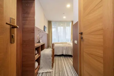 a room with a door leading to a bedroom at Nėris Inn Terraces in Vilnius