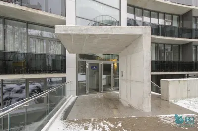 an entrance to a building with snow on the ground at Salt Apartments in Druskininkai
