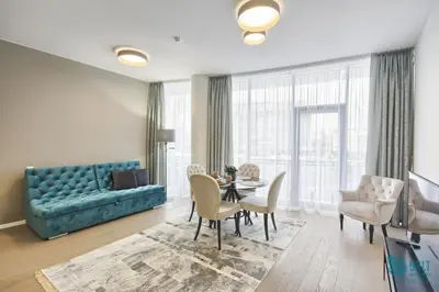 a living room with a couch and a table and chairs at Salt Apartments in Druskininkai