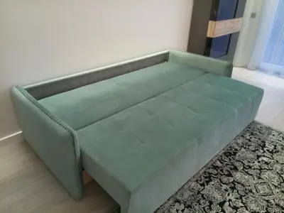 a green couch in a room with a rug at NEW J&R Apartment near Girstutis, Free private parking & Self Check-In in Kaunas
