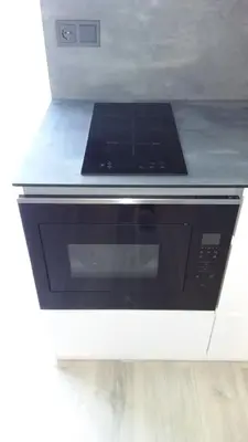 a black and white microwave oven in a kitchen at NEW J&R Apartment near Girstutis, Free private parking & Self Check-In in Kaunas