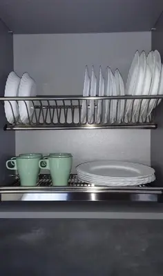 a kitchen with plates and cups on a shelf at NEW J&R Apartment near Girstutis, Free private parking & Self Check-In in Kaunas