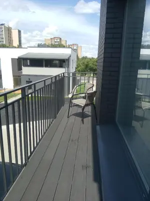 a bench sitting on a deck on a building at NEW J&R Apartment near Girstutis, Free private parking & Self Check-In in Kaunas