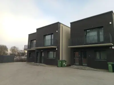a two story black building with two balconies at NEW J&R Apartment near Girstutis, Free private parking & Self Check-In in Kaunas