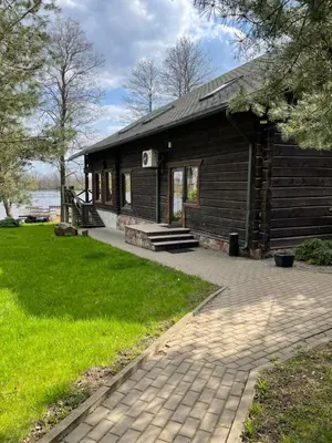 a log cabin with a walkway in front of it at Kurėnų Užeigos Svečių Namai in Kurėnai