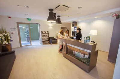 two women standing at a counter in a salon at Goda Hotel & Spa in Druskininkai