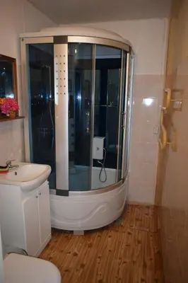 a bathroom with a shower and a sink at Chernobyl type rooms in a block flat house in Šiauliai