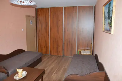 a small room with a bed and a table at Chernobyl type rooms in a block flat house in Šiauliai
