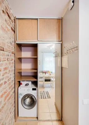 a kitchen with a washer and dryer in a room at Editas apartament in Kaunas