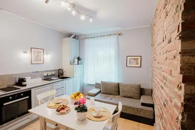 a kitchen and living room with a table and a couch at Editas apartament in Kaunas