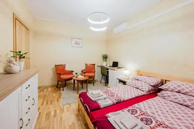 a bedroom with a bed and a desk and a table at Editas apartament in Kaunas