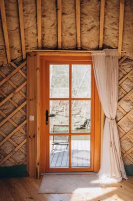 an open door in a room with a window at VasaRojaus Jurta in Birštonas