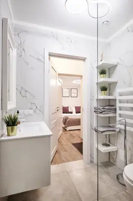 a white bathroom with a sink and a toilet at Owls Hill Apartment in Kaunas