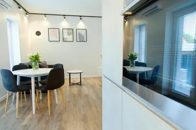 a meeting room with a table and chairs at Owls Hill Apartment in Kaunas