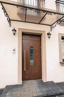 a brown door on the side of a building at Owls Hill Apartment in Kaunas