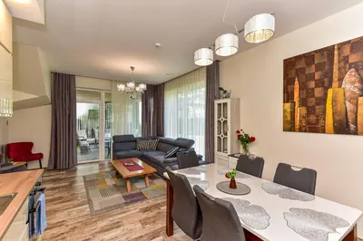 a living room with a table and a couch at Druskininkų Šlaitas in Druskininkai
