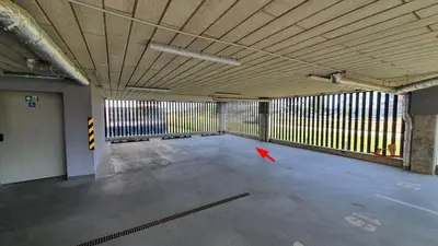 an empty parking garage with a red object in it at Bitenu Studio in Vilnius
