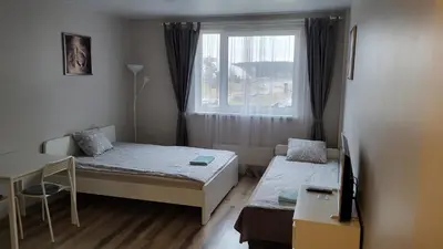 a small room with two beds and a window at Bitenu Studio in Vilnius