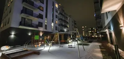 a playground in front of a building at night at Bitenu Studio in Vilnius