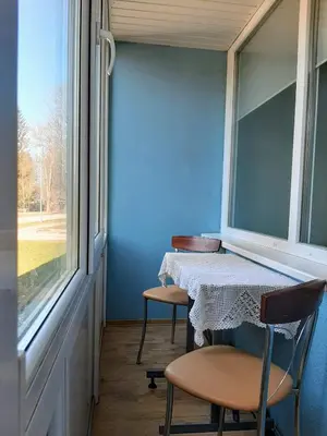 a table and two chairs in a room with a window at Irene apartments in Druskininkai