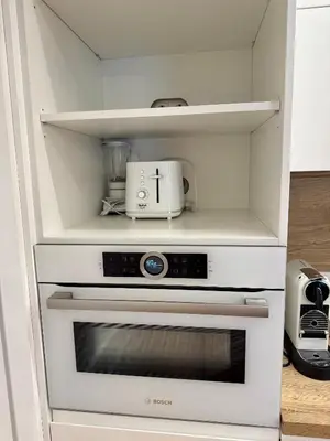 a kitchen with a white oven with a appliance at Varpo 17 in Šiauliai