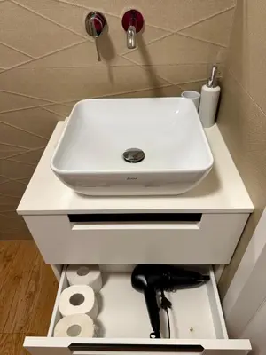 a white sink on a white counter in a bathroom at Varpo 17 in Šiauliai