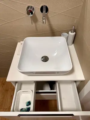 a white sink on a white counter in a bathroom at Varpo 17 in Šiauliai