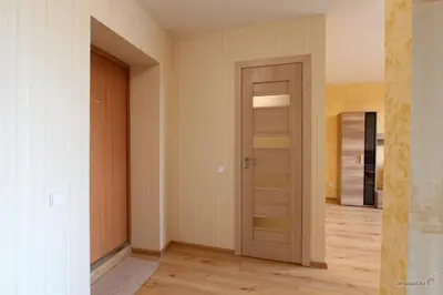 an empty room with a door and a hallway at Lukšio Apartment in Šiauliai