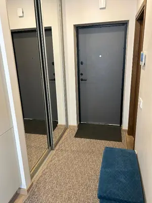 a hallway with two glass doors and a blue stool at Your Home - Stylish Studio Apartment in Center, with Balcony & Self Check-in in Vilnius