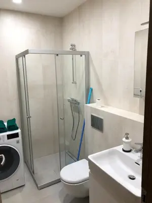 a bathroom with a shower with a toilet and a sink at Your Home - Stylish Studio Apartment in Center, with Balcony & Self Check-in in Vilnius