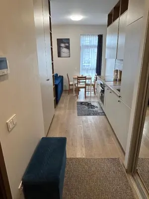 a small kitchen and dining room with a table at Your Home - Stylish Studio Apartment in Center, with Balcony & Self Check-in in Vilnius