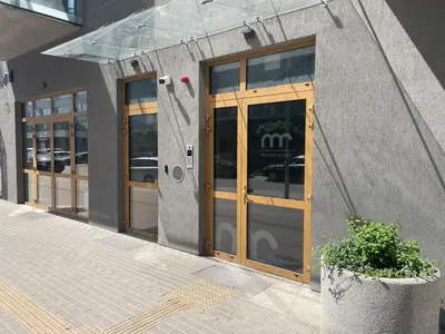 a store front with wooden doors on a building at Your Home - Stylish Studio Apartment in Center, with Balcony & Self Check-in in Vilnius