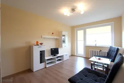 a living room with a couch and a tv at Tilžės Apartment in Šiauliai