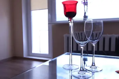 two wine glasses sitting on top of a table at Tilžės Apartment in Šiauliai