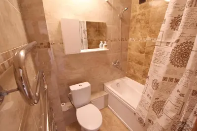 a bathroom with a toilet and a shower and a sink at Tilžės Apartment in Šiauliai