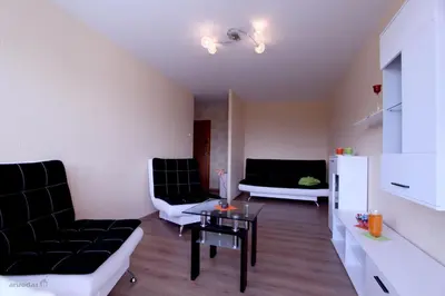 a living room with two couches and a table at Tilžės Apartment in Šiauliai