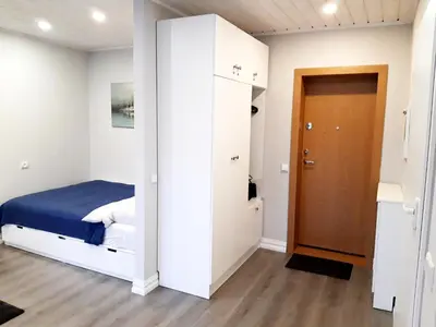a small bedroom with a bed and a closet at Alytus Ziburio studio in Alytus