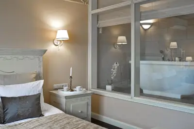 a bedroom with a bed and a window with a candle at Viva Trakai in Trakai