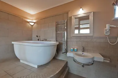 a bathroom with a large tub and a sink at Viva Trakai in Trakai