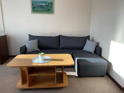 a living room with a blue couch and a coffee table at Alanta 