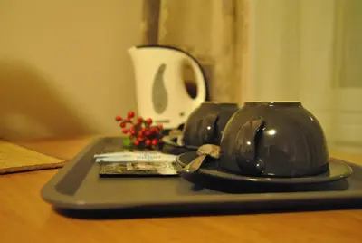 a tray with a tea kettle on a table at Alanta 