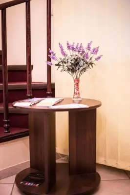 a table with a vase of flowers on it at Alanta 