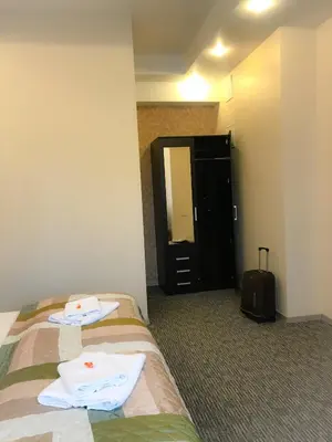 a hotel room with a bed with towels on it at Alanta 