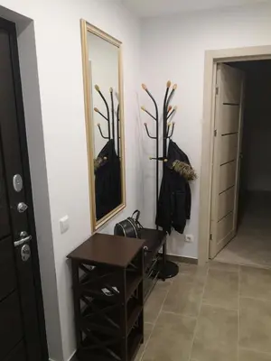 a dressing room with a table and a mirror at Parko apartamentai in Panevėžys