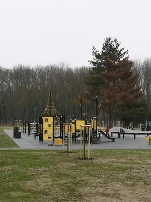 a playground in a park with yellow equipment in a park at Parko apartamentai in Panevėžys