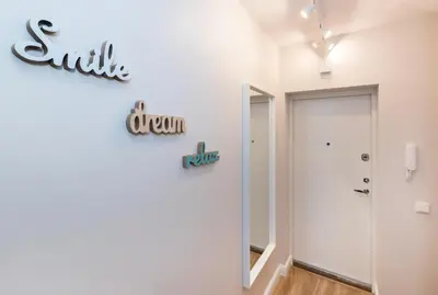 a white room with a sign on the wall at Relax apartments near Egle in Druskininkai
